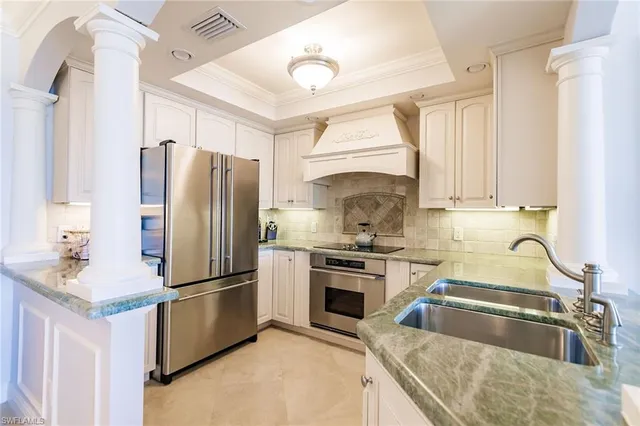 a kitchen with a refrigerator sink and stove