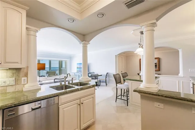 a living room with granite countertop furniture a sink and a window
