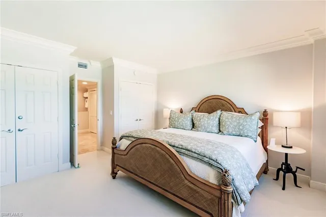 a bedroom with a bed and a lamp