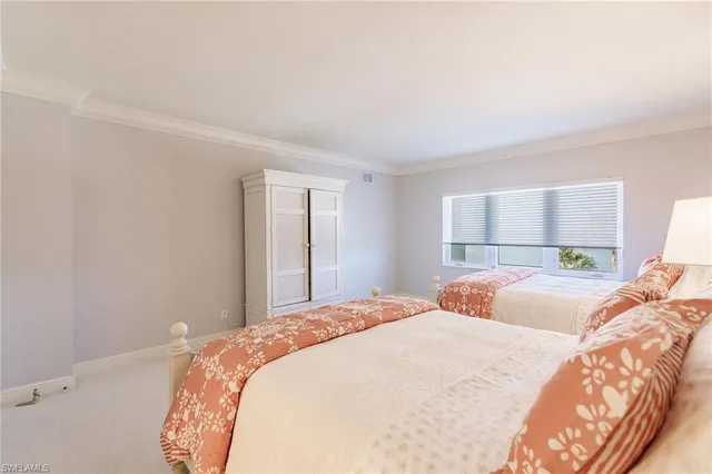 a bedroom with a large bed and a large window