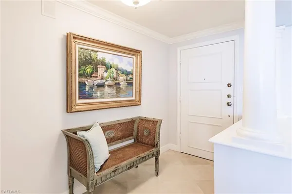 a hallway with a bench and a painting