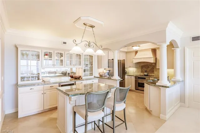a kitchen with stainless steel appliances kitchen island granite countertop a sink and cabinets