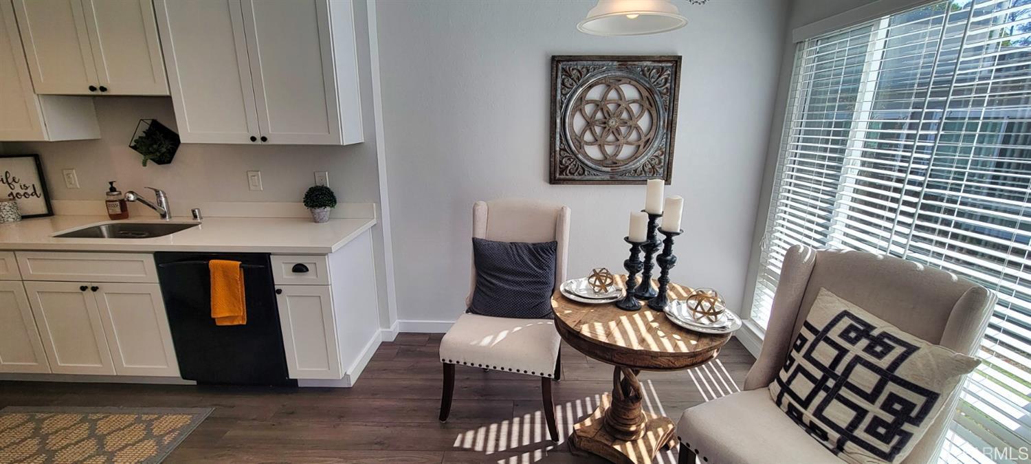 1200 Kenwal Road, Unit D Concord, CA 94521 - Photo 2 of 14 a view of a kitchen with stainless steel appliances wooden floor and table chairs