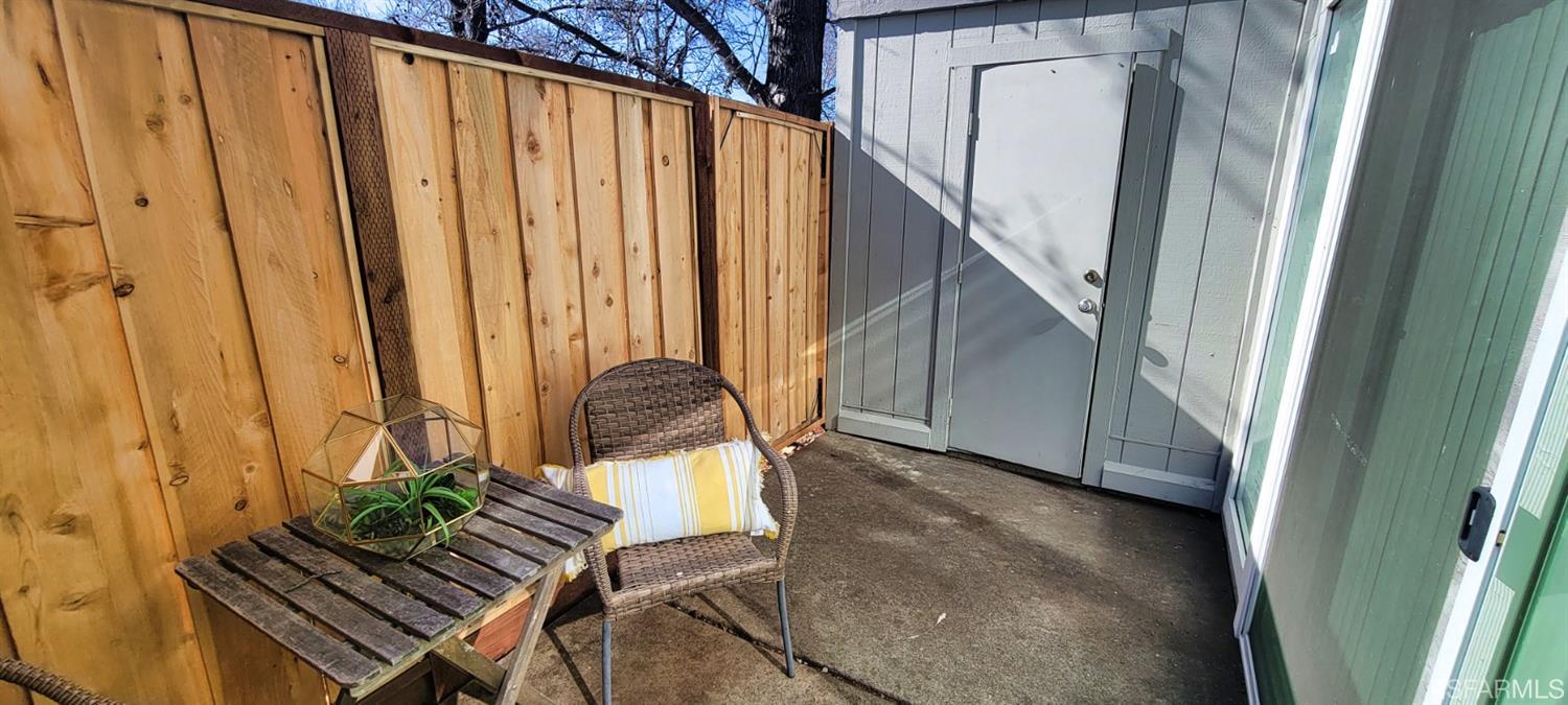 1200 Kenwal Road, Unit D Concord, CA 94521 - Photo 9 of 14 a view of balcony with wooden floor and a potted plant