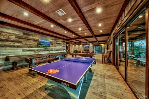 a sitting area with pool table and chairs
