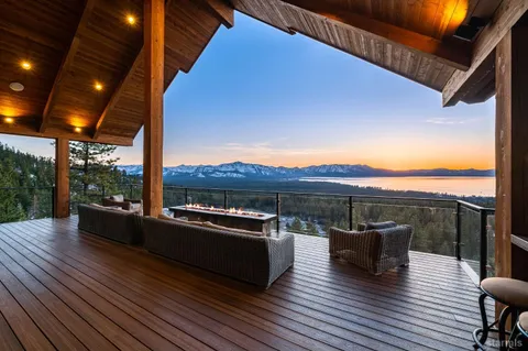 a view of a terrace with couches and wooden floor