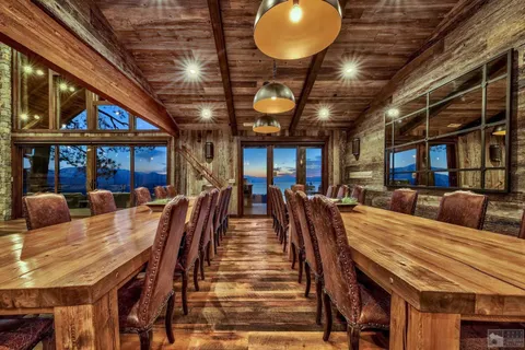 a dining room with lots of wooden furniture and a chandelier
