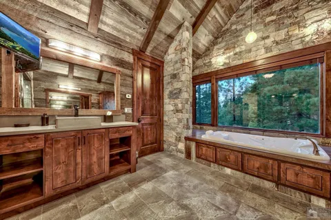 a large room with kitchen island a large window in it