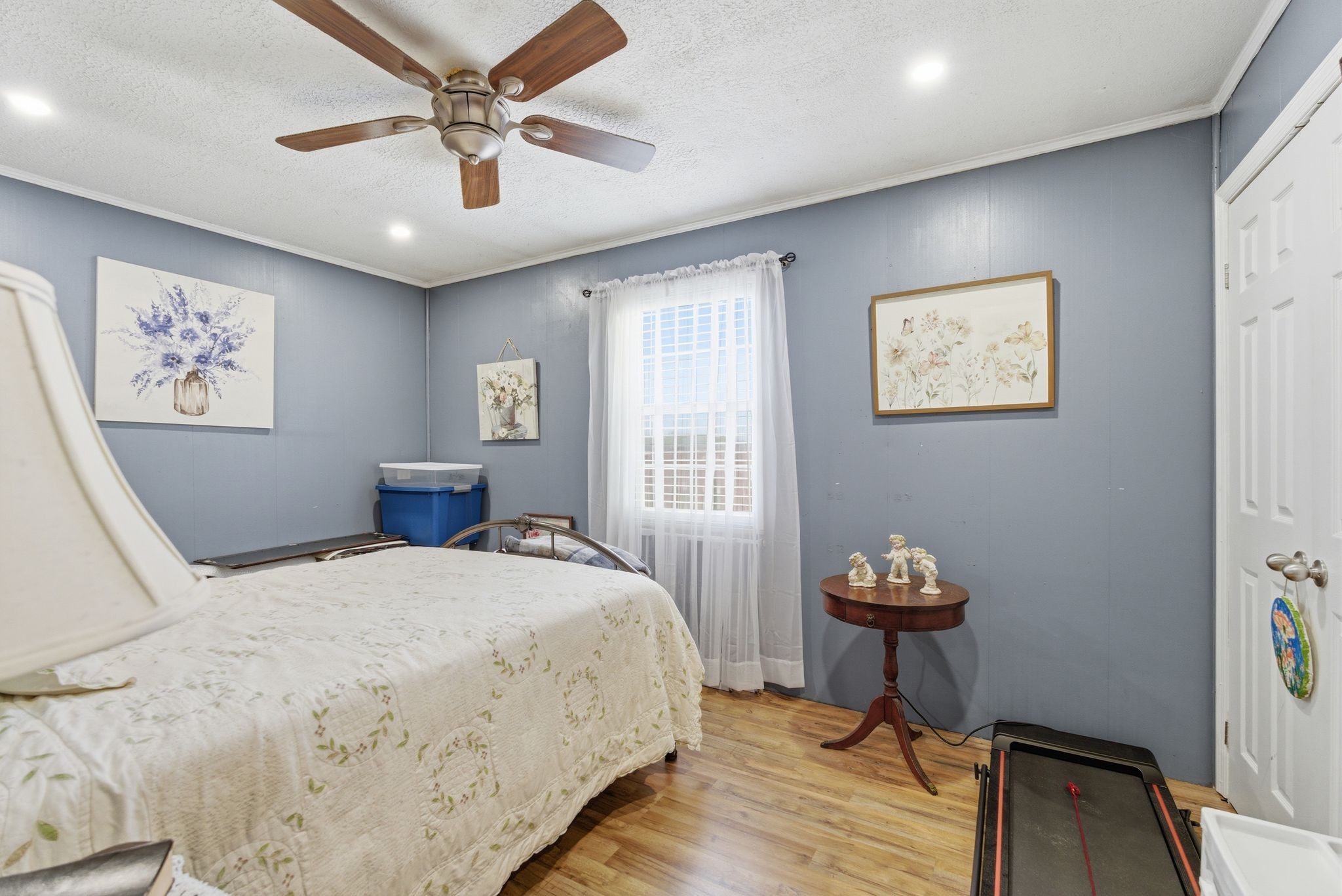 404 Logan Chapel Road Hillsboro, TN 37342 - Photo 18 of 38 a bedroom with a bed and a chandelier