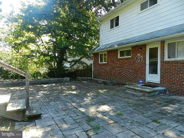 6707 Glenkirk Road Baltimore, MD 21239 - Photo 22 of 25 a view of a house with a yard