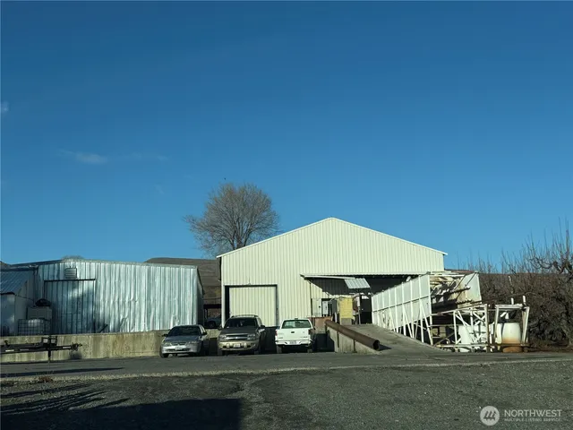 a car parked in front of a white house