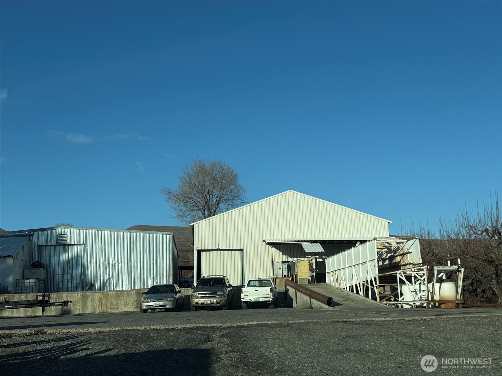 556 Jack Wells Road Bridgeport, WA 98813 - Photo 13 of 13 a car parked in front of a white house