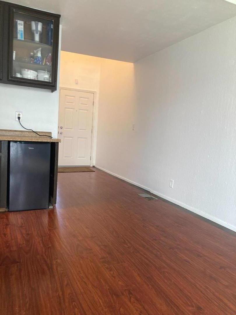 3660 Wells Road Oakley, CA 94561 - Photo 6 of 63 a view of an empty room with wooden floor and a window