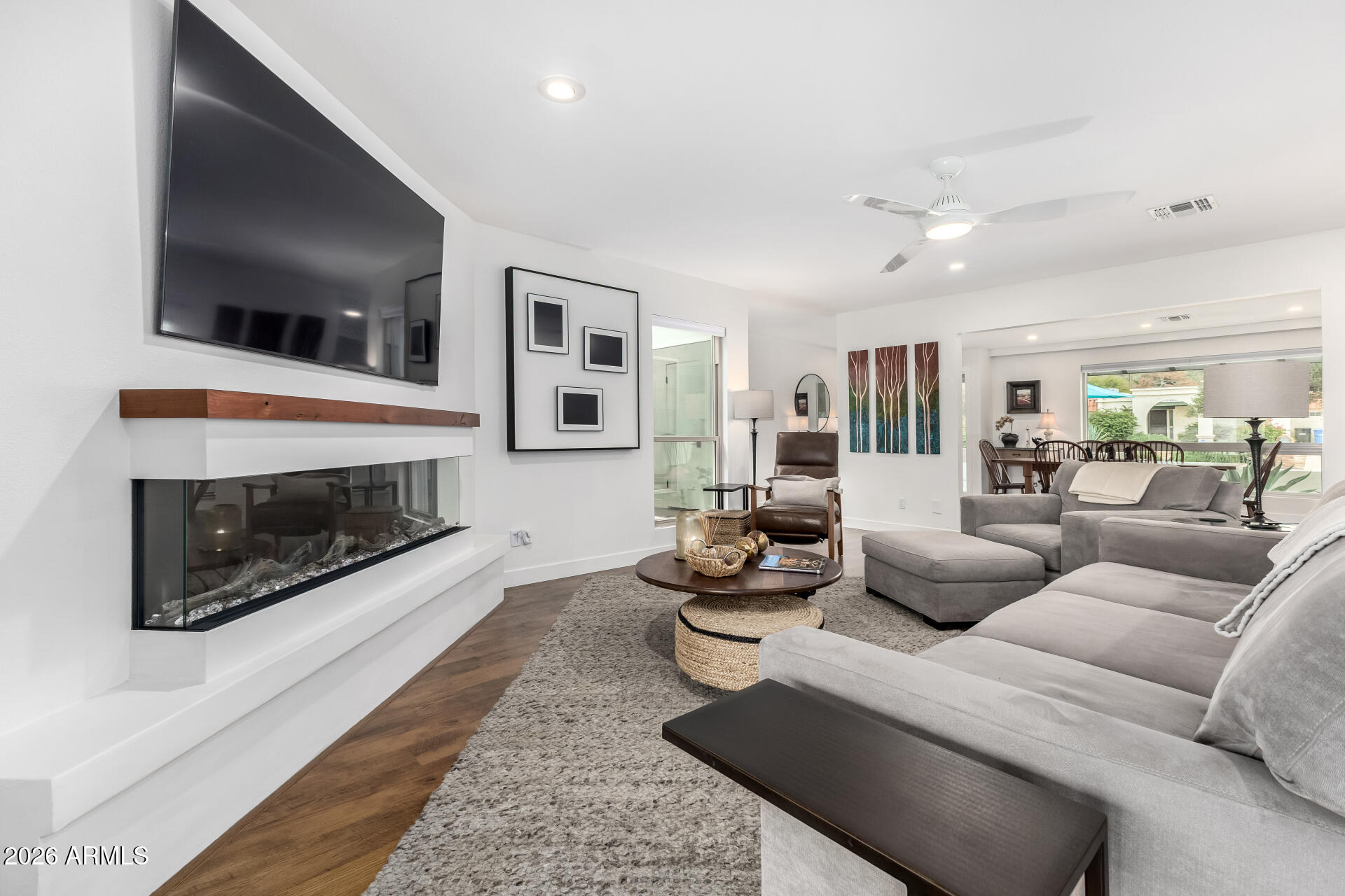 3220 East Hatcher Road Phoenix, AZ 85028 - Photo 13 of 50 a living room with furniture a flat screen tv and a fireplace
