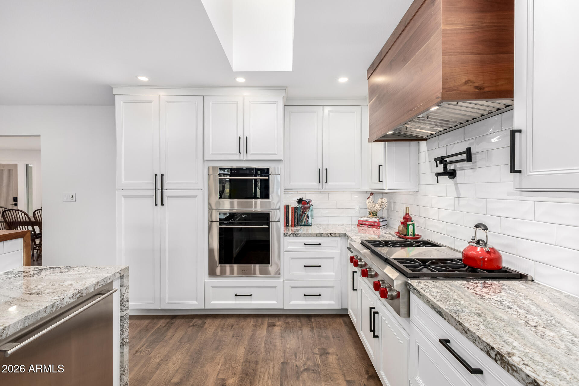 3220 East Hatcher Road Phoenix, AZ 85028 - Photo 18 of 50 a kitchen with stainless steel appliances granite countertop a stove a sink and a refrigerator