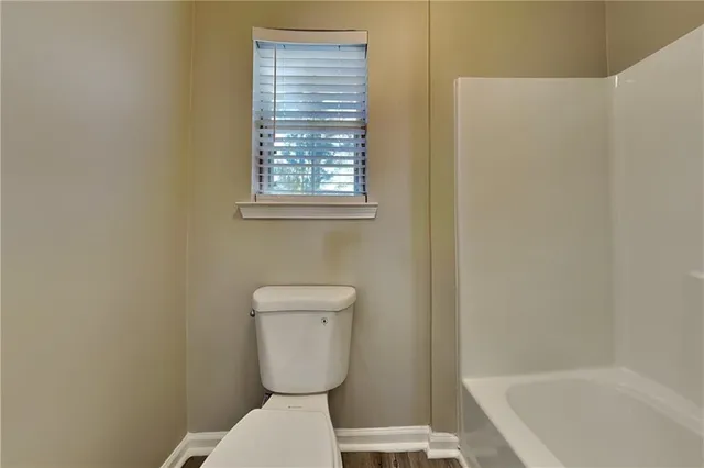 a bathroom with a toilet and a bathtub