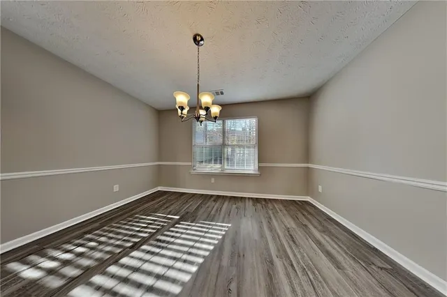 a view of an empty room with glass door