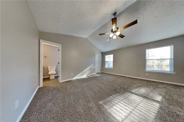a view of empty room with ceiling fan