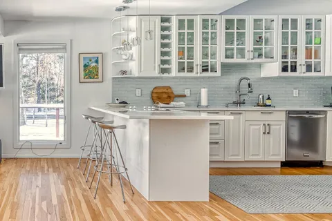 a kitchen with stainless steel appliances granite countertop a sink stove and cabinets