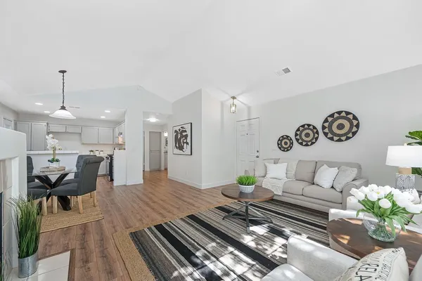 a dining room with furniture and wooden floor