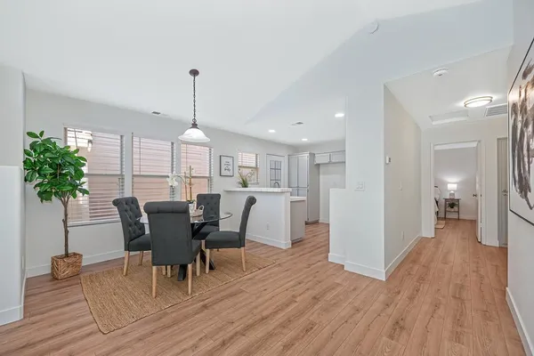 a kitchen with a sink cabinets and wooden floor