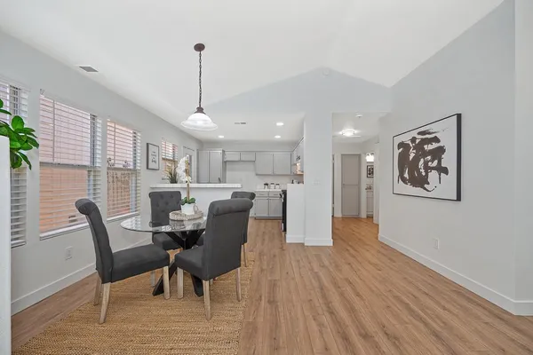 a view of a room that has a table and a chair in it