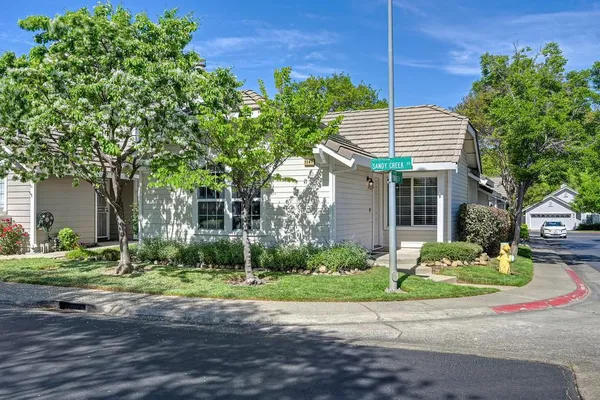a front view of a house with a yard and a garage