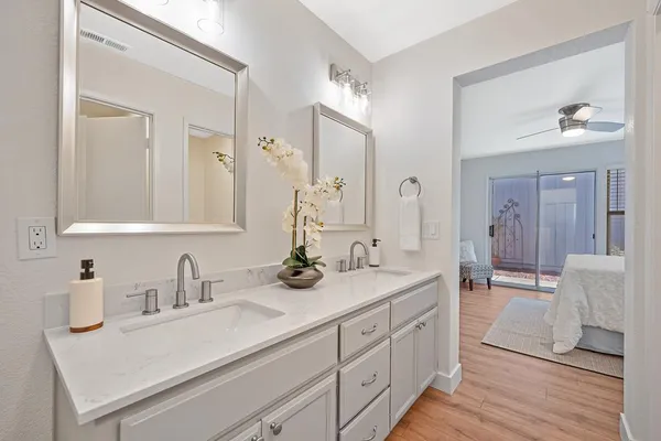 a view of a house with a yard and potted plants