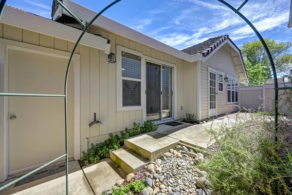 an aerial view of residential houses with outdoor space and trees