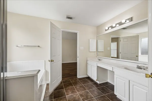 a spacious bathroom with a shower and a sink