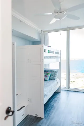 a view of room with wooden floor and windows