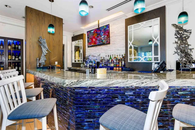 a view of a livingroom with furniture wooden floor and a large window