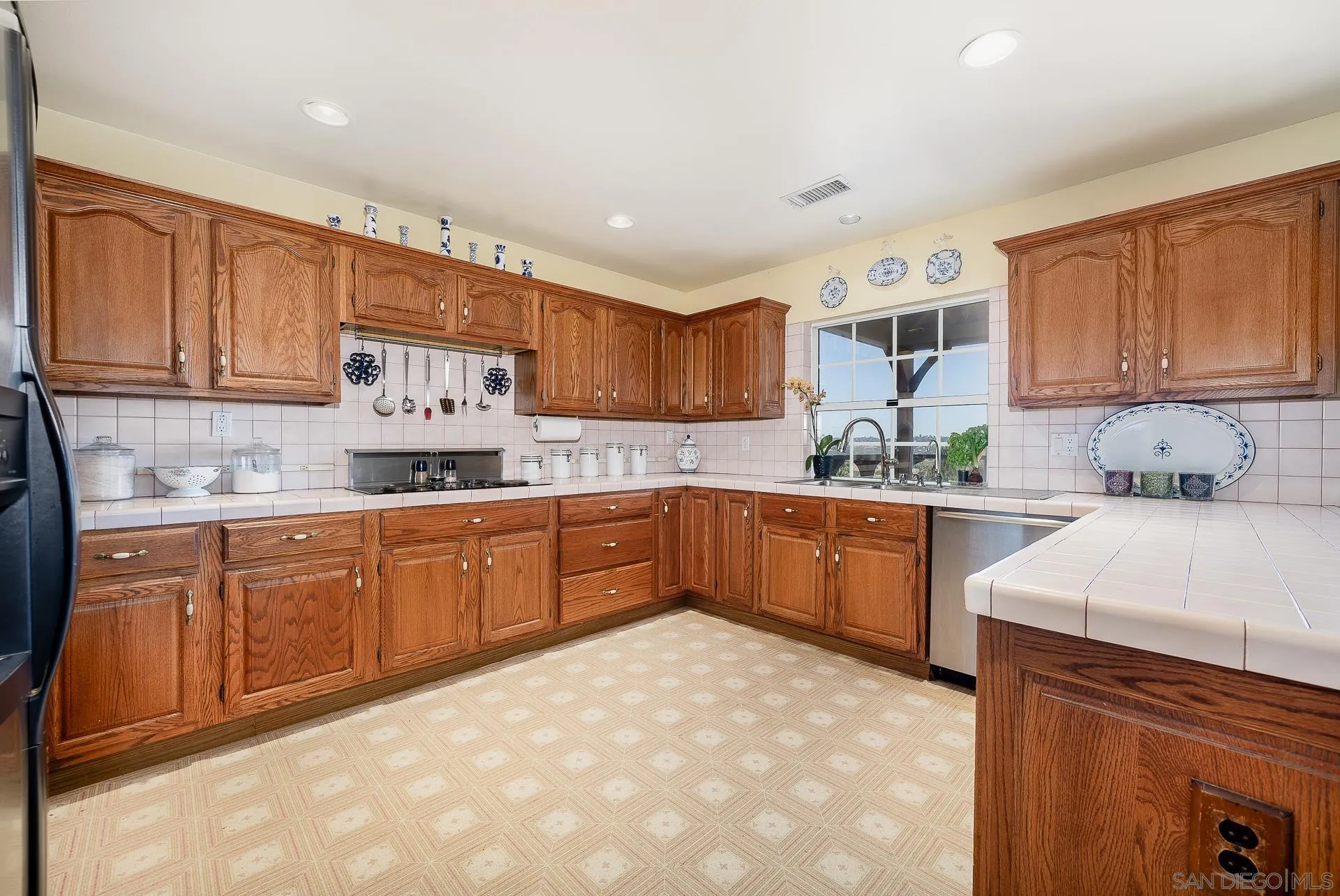 4241 Via El Dorado Fallbrook, CA 92028 - Photo 19 of 64 a kitchen with stainless steel appliances granite countertop a stove sink and cabinets