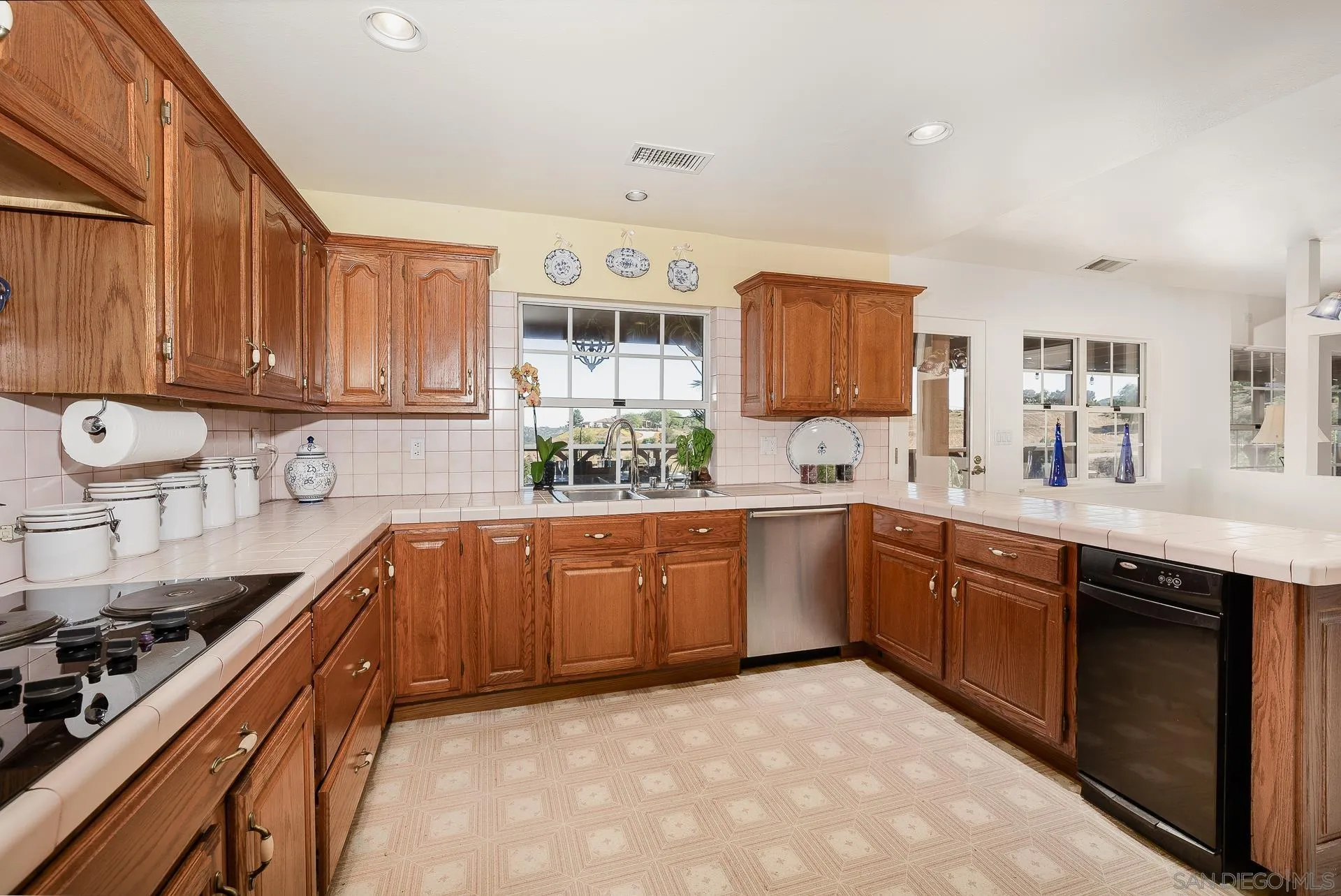 4241 Via El Dorado Fallbrook, CA 92028 - Photo 20 of 64 a kitchen with stainless steel appliances granite countertop a sink stove and cabinets