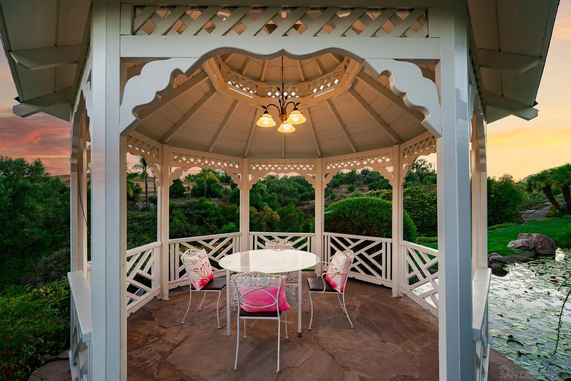 4241 Via El Dorado Fallbrook, CA 92028 - Photo 9 of 64 a view of a patio with a dining table and chairs under an umbrella