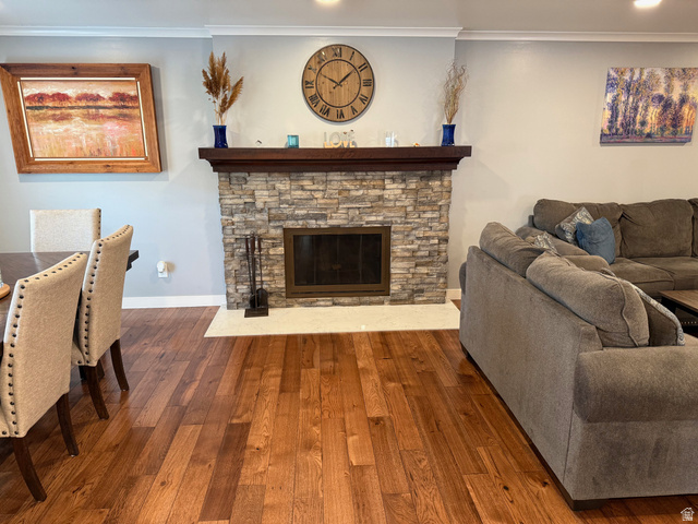 362 East 9150th Street South Sandy, UT 84070 - Photo 6 of 41 Living room with solid hickory flooring crown molding, a stone fireplace, and recessed lighting