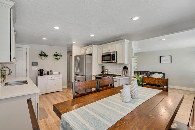 48 Moon Ridge Drive Murray, UT 84107 - Photo 10 of 30 Open-concept living space featuring a dining area, kitchen, and partial living room