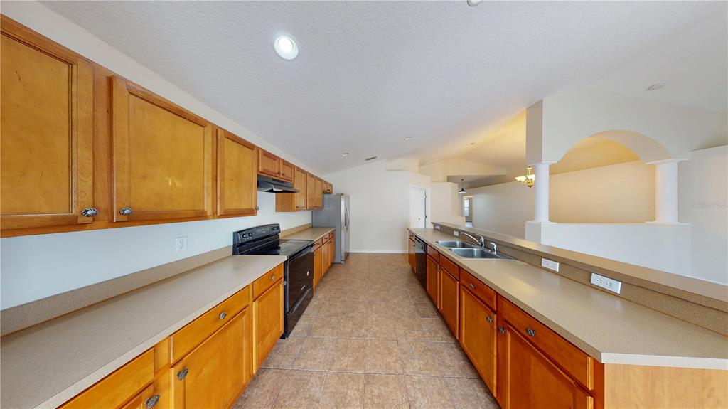3209 Murray Hill Loop Kissimmee, FL 34758 - Photo 15 of 23 a kitchen with stainless steel appliances a sink and a stove