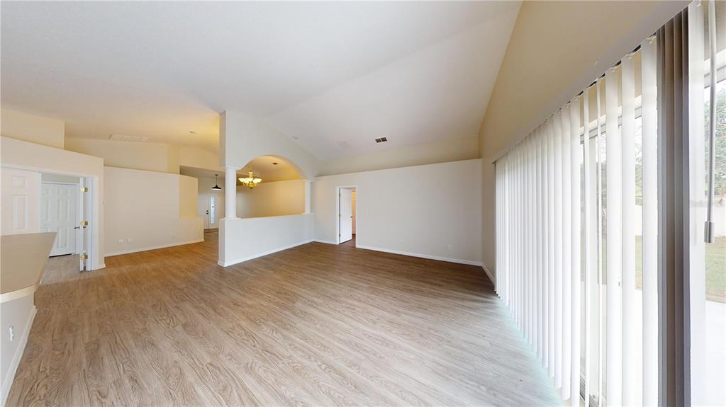 3209 Murray Hill Loop Kissimmee, FL 34758 - Photo 16 of 23 a view of empty room with wooden floor and fan