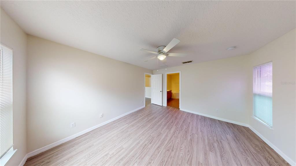 3209 Murray Hill Loop Kissimmee, FL 34758 - Photo 17 of 23 a view of an empty room with wooden floor