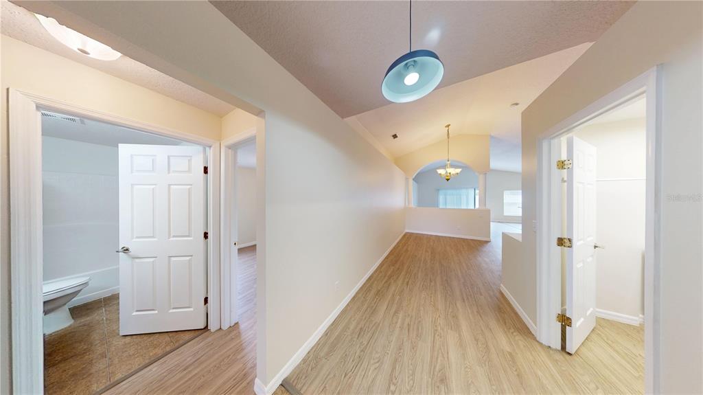 3209 Murray Hill Loop Kissimmee, FL 34758 - Photo 4 of 23 a view of a hallway with wooden floor and staircase