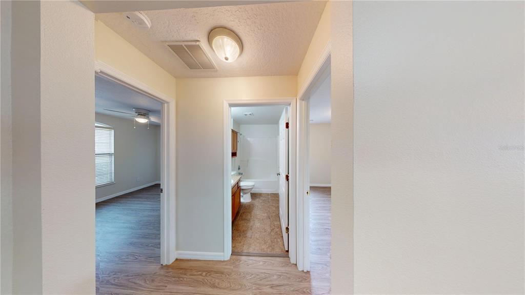 3209 Murray Hill Loop Kissimmee, FL 34758 - Photo 5 of 23 a view of a bathroom from a hallway