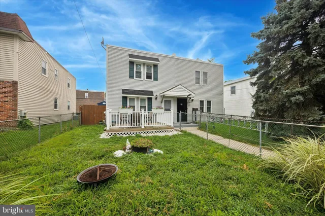 a view of a house with backyard sitting area and swimming pool