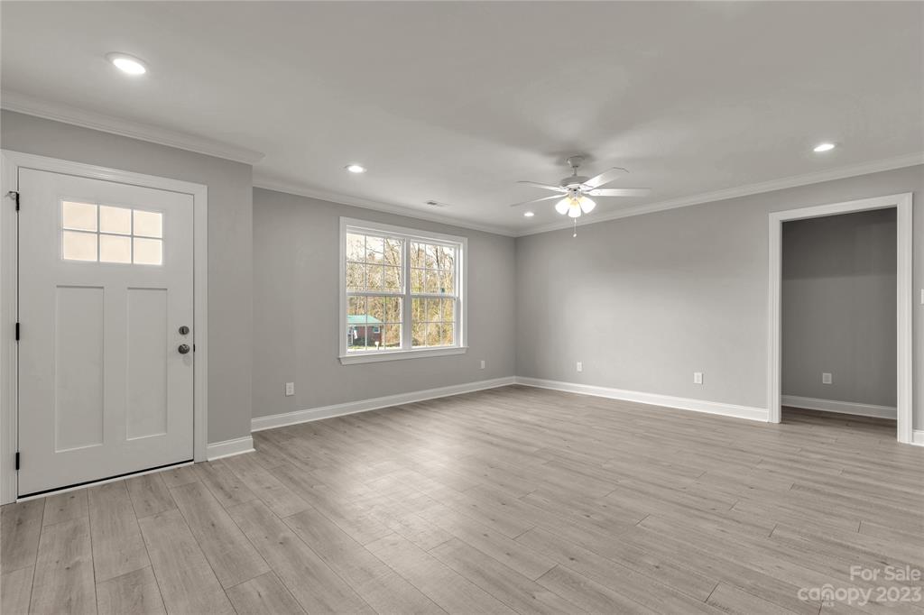6724 State Rd S-29-555 Kershaw, SC 29067 - Photo 12 of 31 an empty room with wooden floor and windows