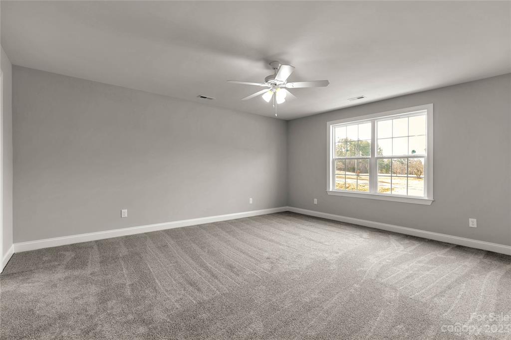 6724 State Rd S-29-555 Kershaw, SC 29067 - Photo 13 of 31 an empty room with a window and a ceiling fan