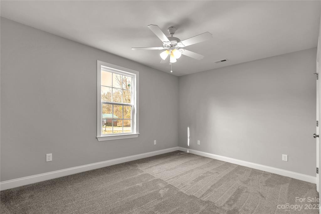 6724 State Rd S-29-555 Kershaw, SC 29067 - Photo 15 of 31 an empty room with windows and fan