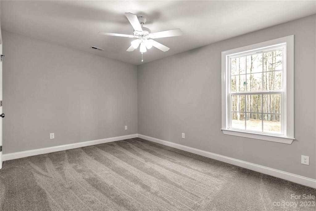 6724 State Rd S-29-555 Kershaw, SC 29067 - Photo 17 of 31 an empty room with wooden floor and windows