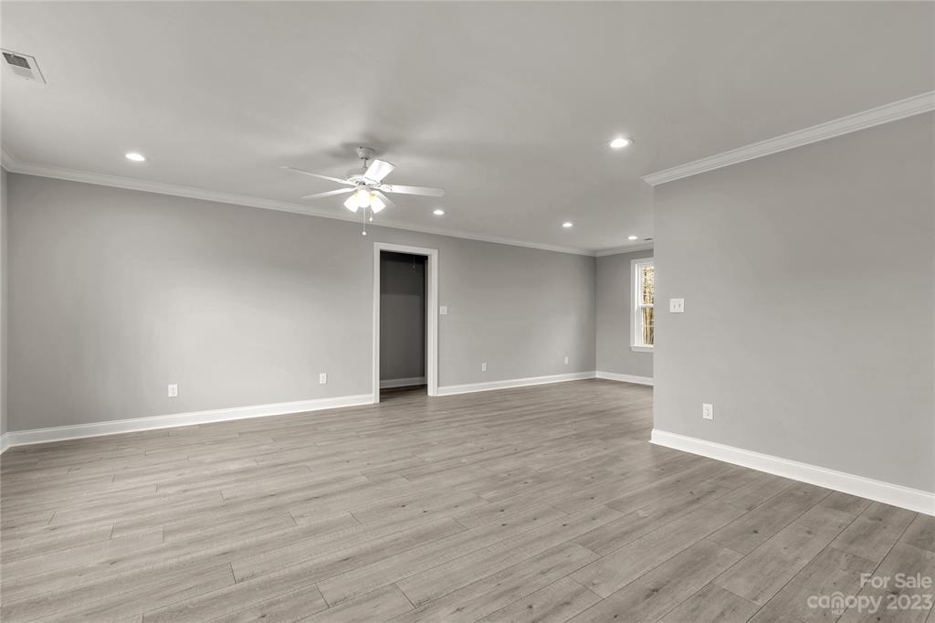 6724 State Rd S-29-555 Kershaw, SC 29067 - Photo 10 of 31 a view of an empty room with wooden floor and a ceiling fan