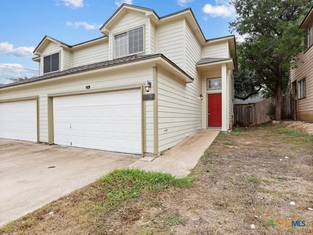 a view of a house with a backyard