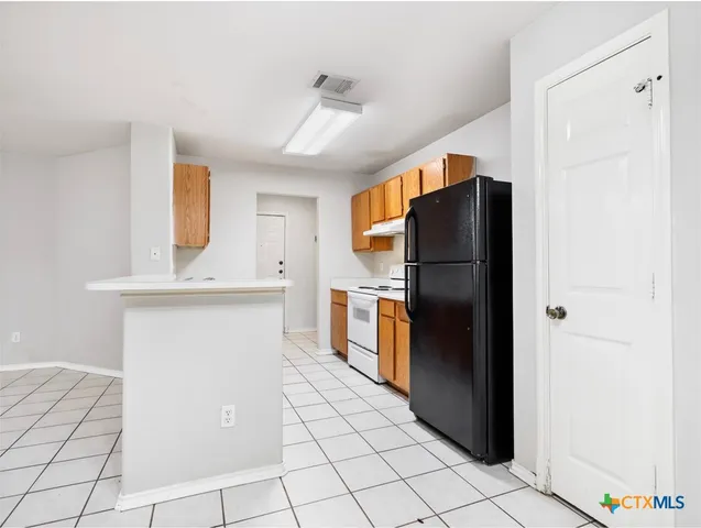 a kitchen with stainless steel appliances a refrigerator and a stove